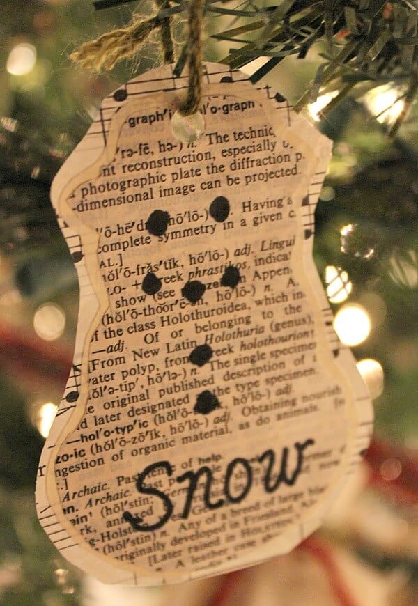 handmade paper snowman ornament using sheet music and old dictionary pages