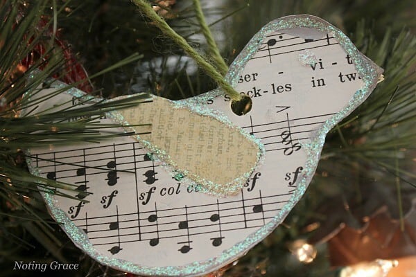 Handmade paper bird Christmas ornament hanging on a tree