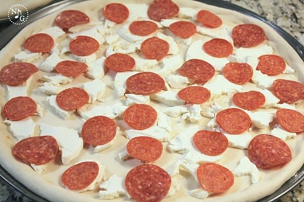 making pepperoni pizza