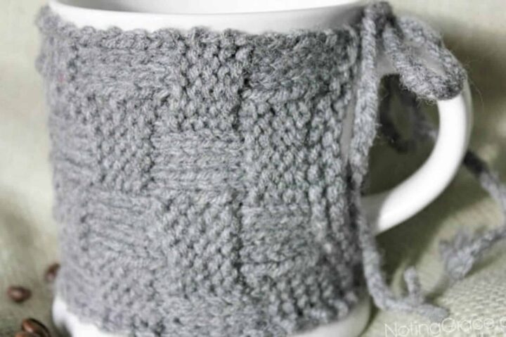 charcoal gray basketweave knit coffee cozy wrapped around a white mug