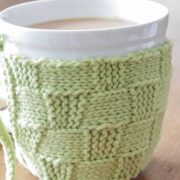lime green basketweave knit coffee cozy wrapped around a white mug
