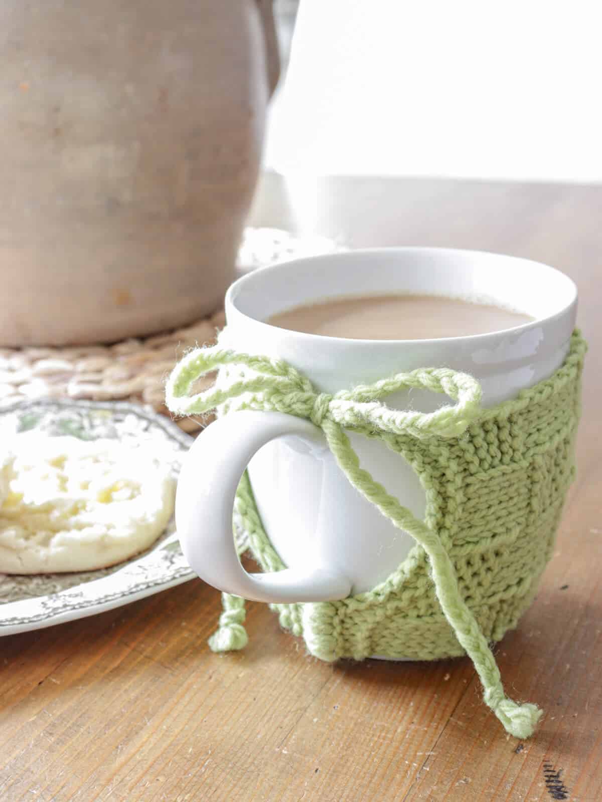 lime green basketweave knit coffee cozy wrapped around a white mug