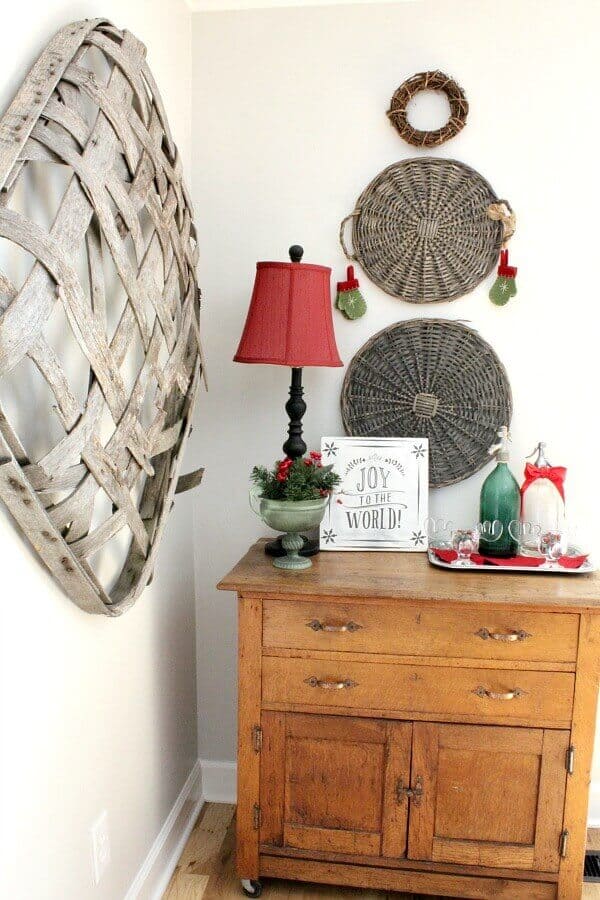 diy christmas wall art using baskets and a wreath to create a wooden snowman.