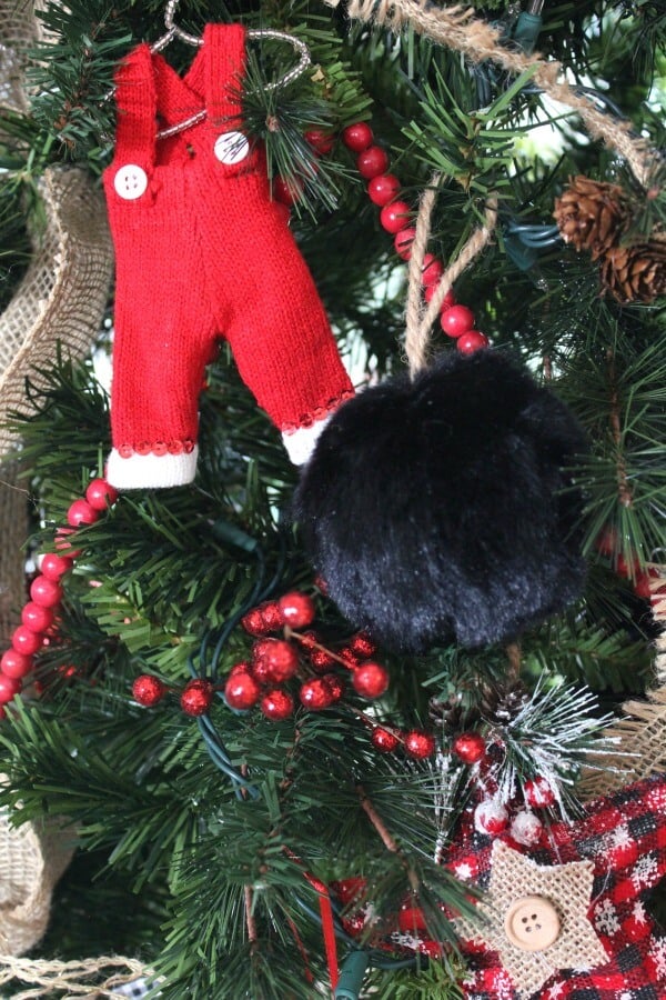 knit overall Christmas ornament hanging on a tree