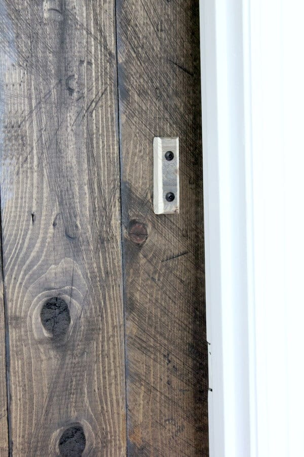Simple DIY Barn door tutorial - Jen @ Noting Grace shares how easily it is to switch out a builder grade door with a sliding barn door.