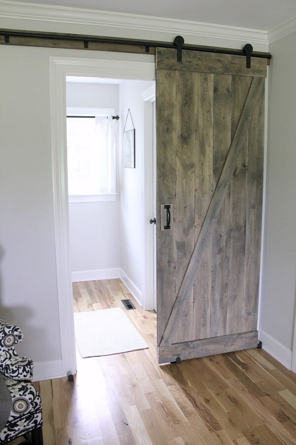 Simple DIY Barn door tutorial - Jen @ Noting Grace shares how easily it is to switch out a builder grade door with a sliding barn door.