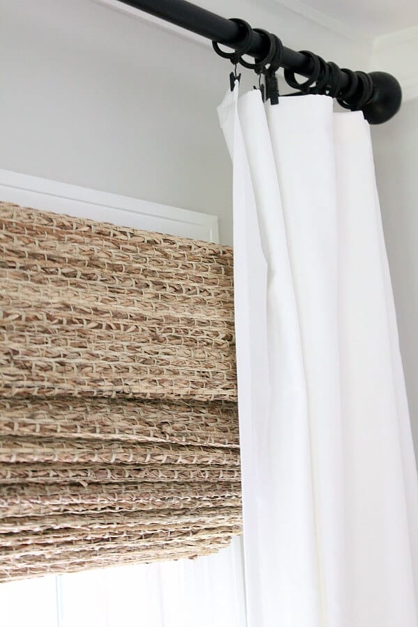 Just a little window dressing - This blogger transformed her windows with homemade curtains and Farmhouse woven shades from The Shade Store