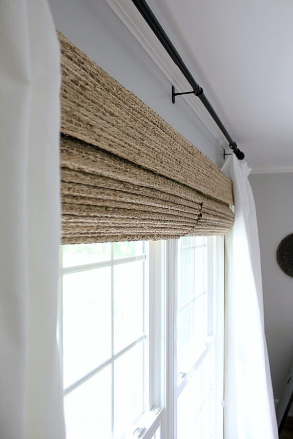 Just a little window dressing - This blogger transformed her windows with homemade curtains and Farmhouse woven shades from The Shade Store