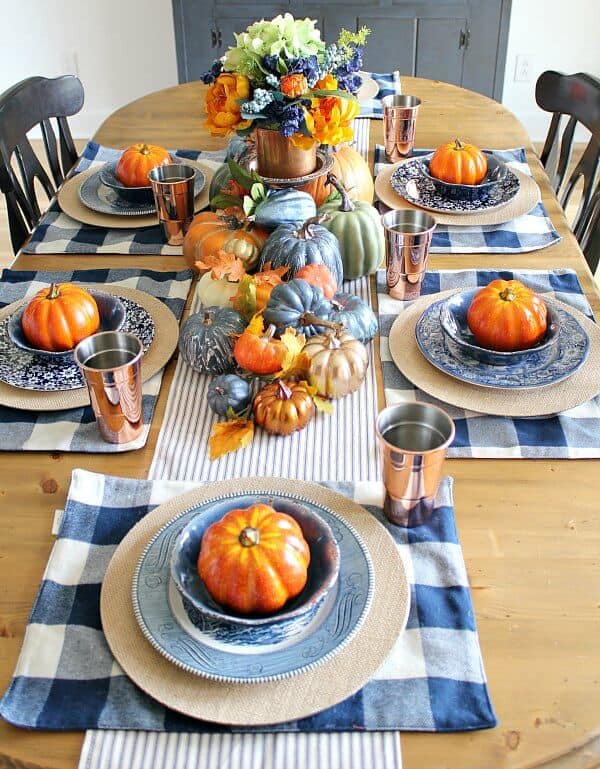Loads of pumpkins, cozy navy hues and hints of copper complete this Copper and Navy Fall Farmhouse Tablescape