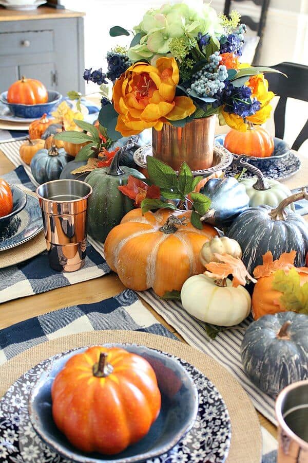 Loads of pumpkins, cozy navy hues and hints of copper complete this Copper and Navy Fall Farmhouse Tablescape