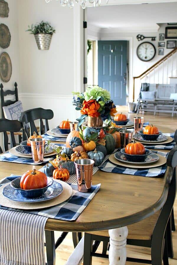 Loads of pumpkins, cozy navy hues and hints of copper complete this Copper and Navy Fall Farmhouse Tablescape