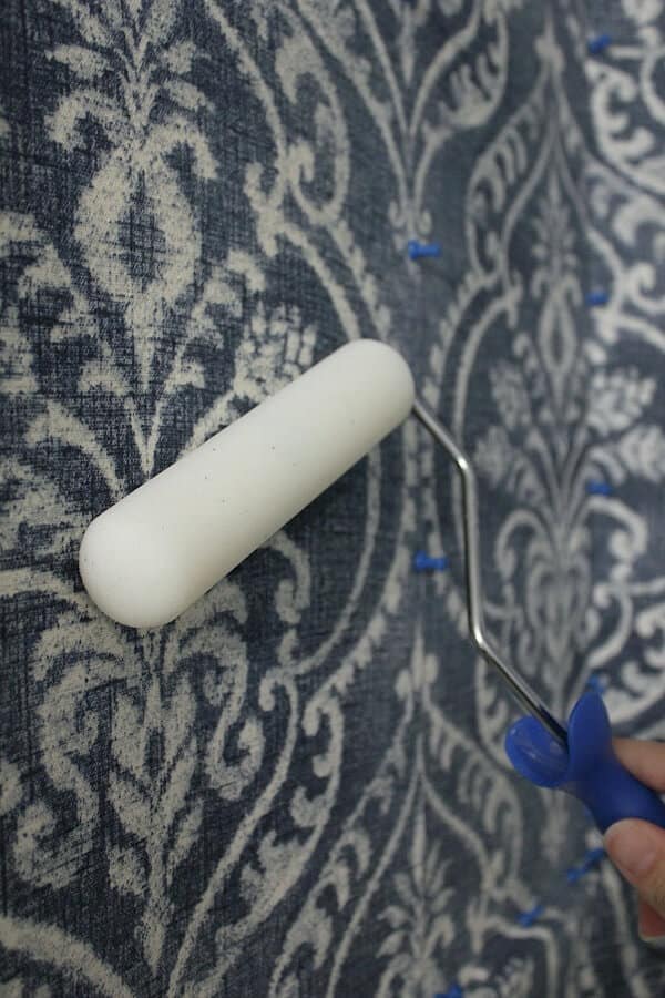 Temporary Wallpaper Tutorial: Using a foam roller, you roll the starch over the fabric