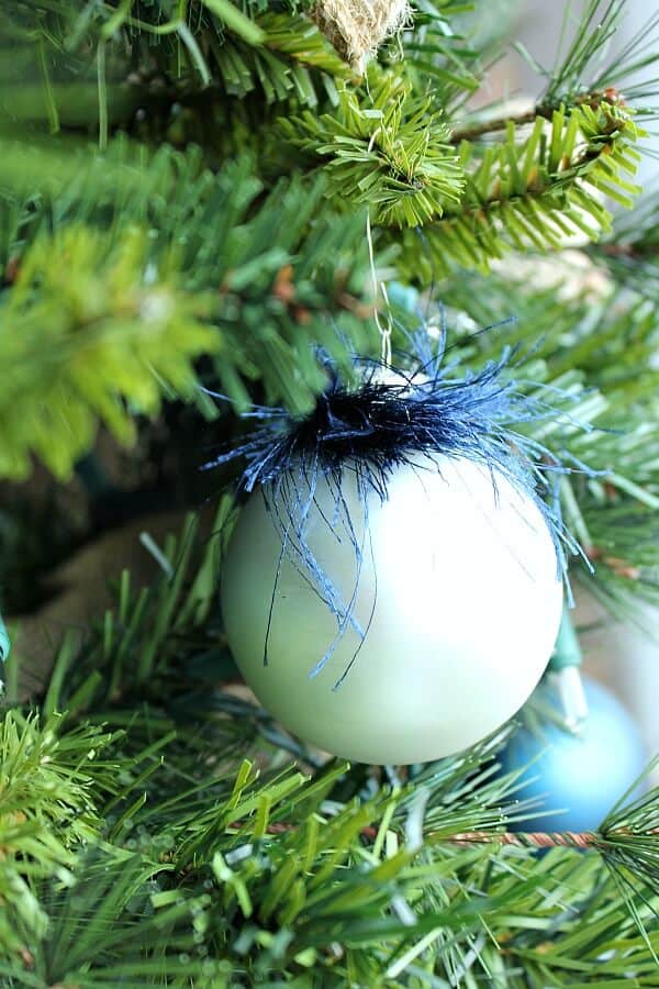 silver ornament with a tinsel yarn topping