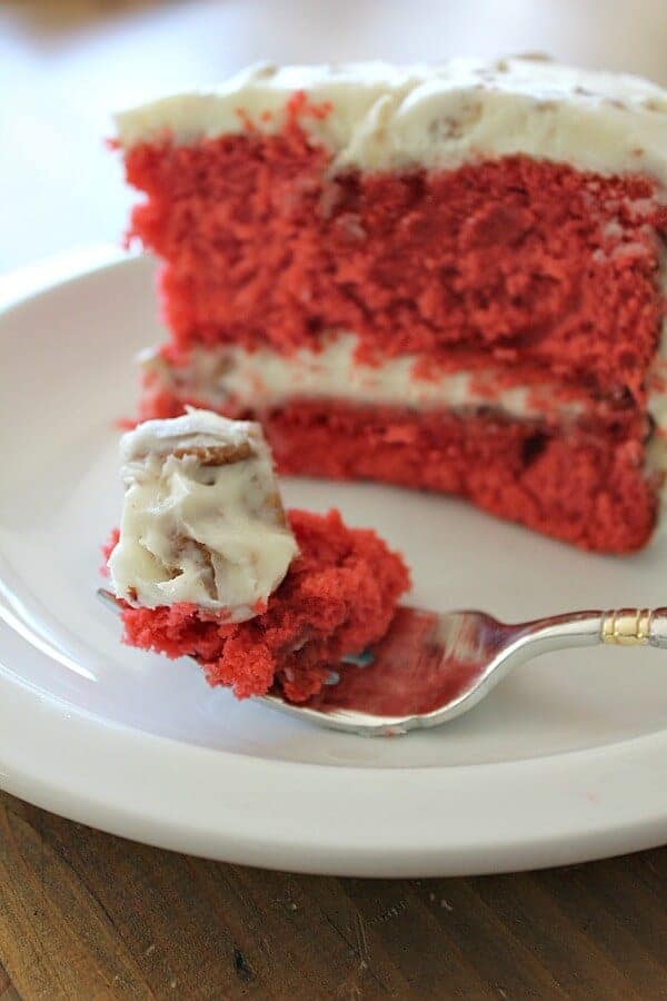 red velvet cake on a silver fork with cream cheese icing