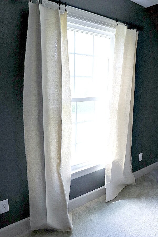 I needed a quick and budget friendly solution for window treatments in my son's room. I found my solution with these easy frayed drop cloth curtains you can make in 5 minutes.