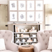 living room with armchairs in front of a wall cabinet that is opening to reveal a hidden tv
