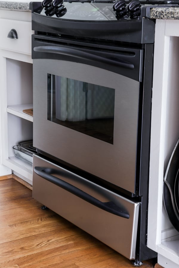 black appliances covered with silver faux panels to create stainless appliances