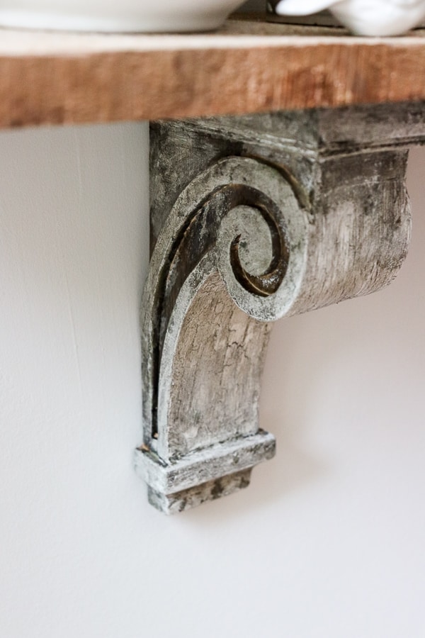 I created a quick and easy DIY shelf for my eat-in kitchen with this easy way to make new corbels look old. A simple tutorial with stunning results!