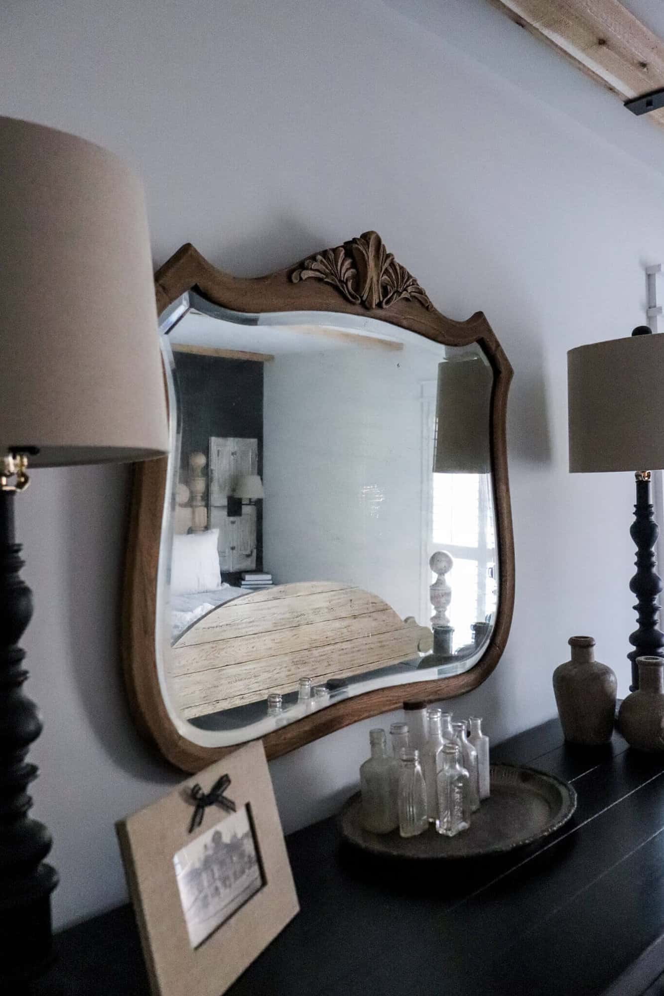 vintage mirror over a black dresser