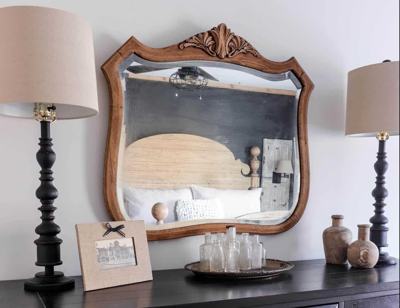 Black dresser with vintage mirror over  with cedar beams