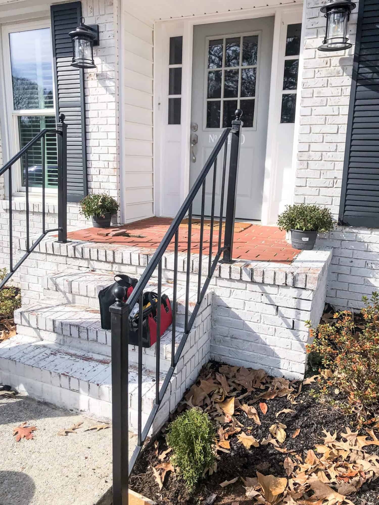 new iron stair railings on brick front porch