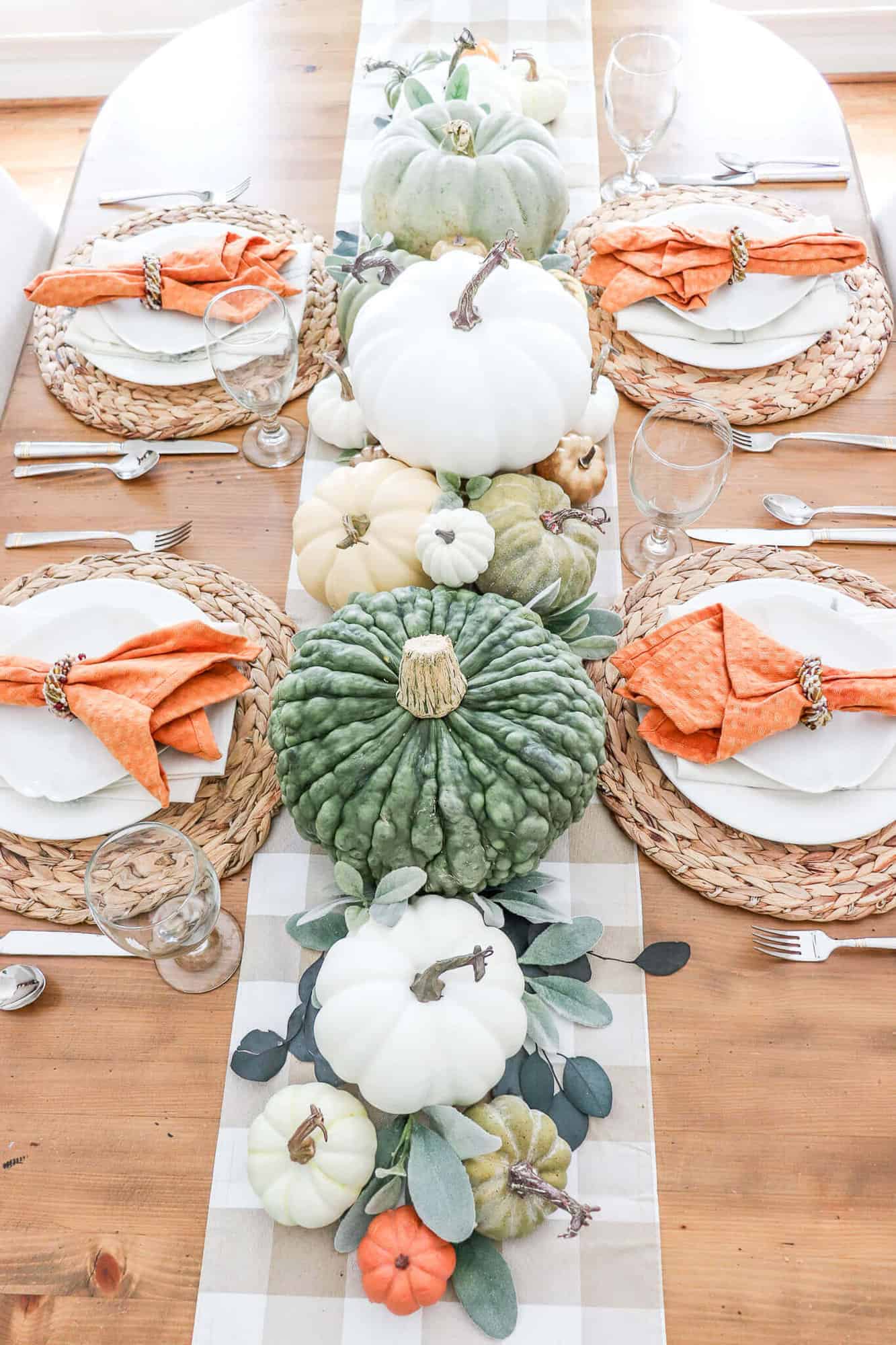 fall pumpkin tablescape with plaid runner and hints of orange