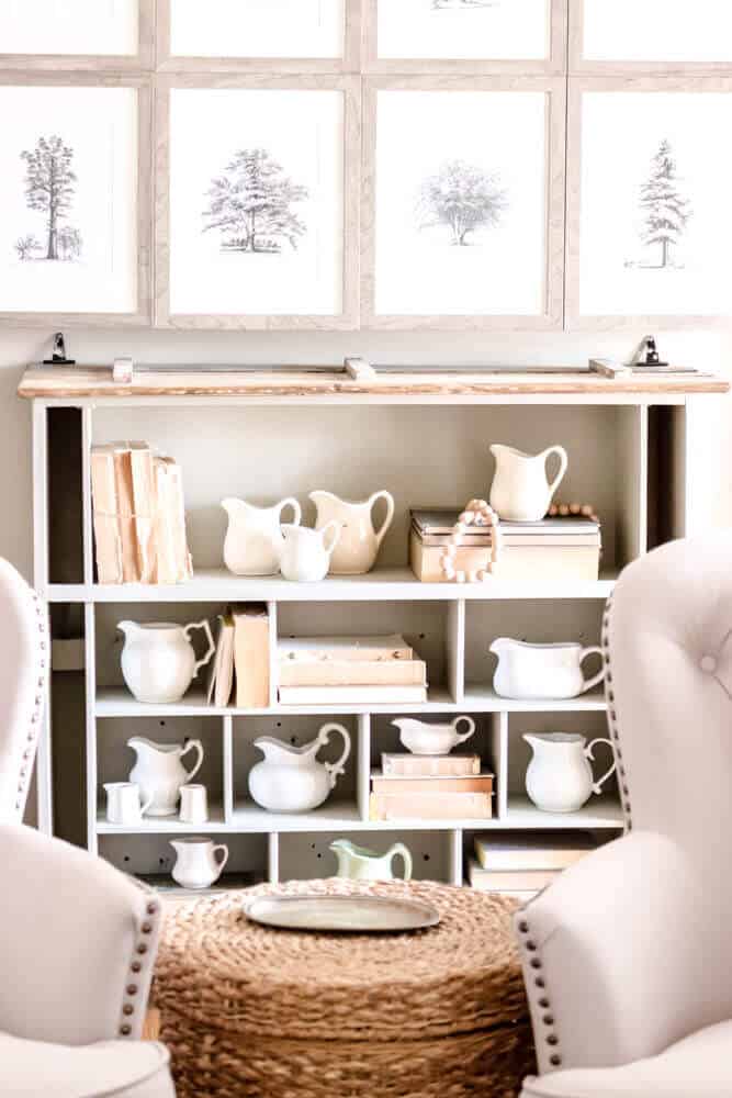 shelves decorated with vintage creamer pitchers and old books