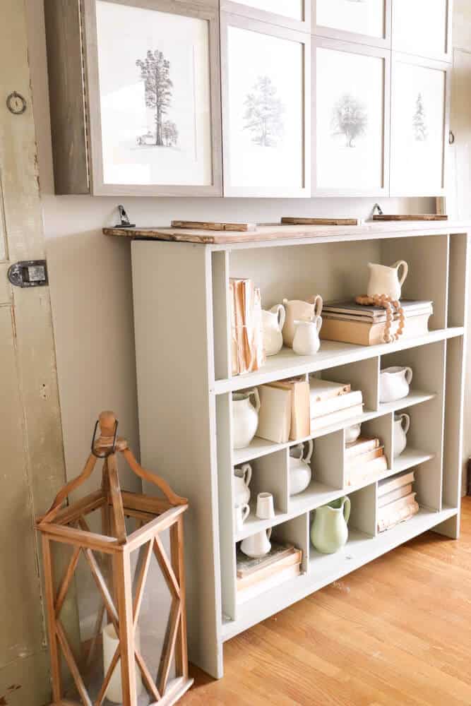 shelves decorated with vintage creamer pitchers and old books