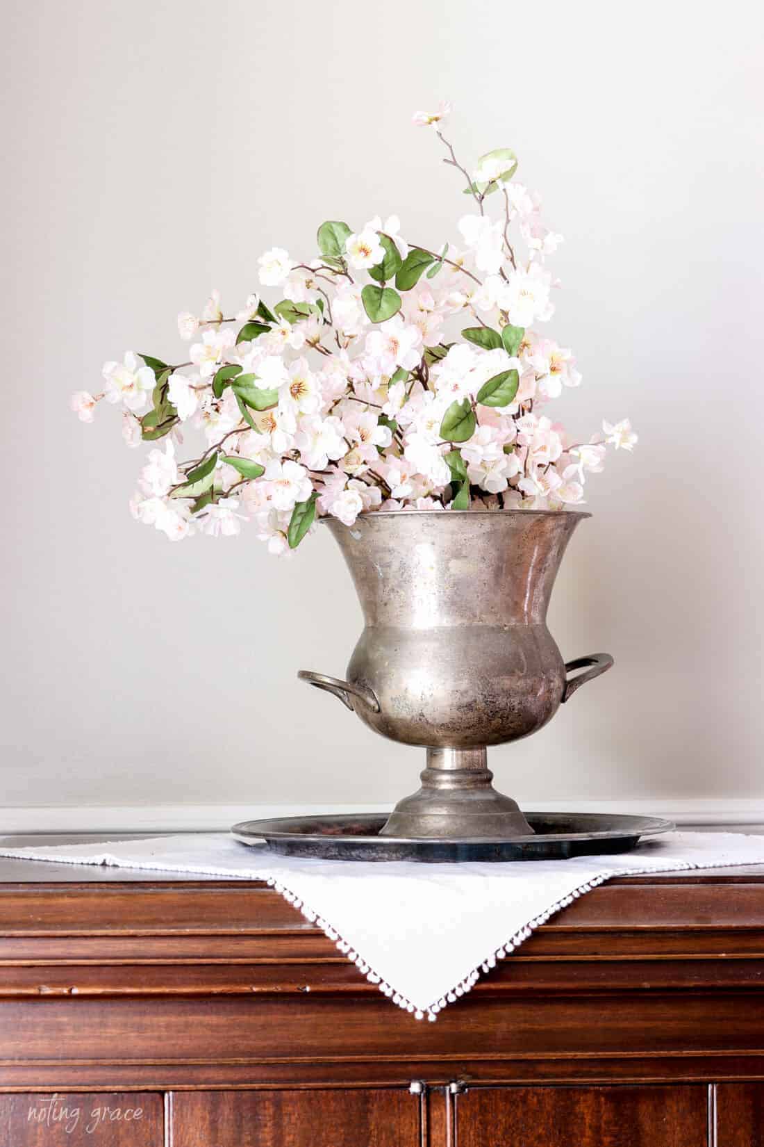 vintage tarnished silver wine cooler filled with cherry blossoms