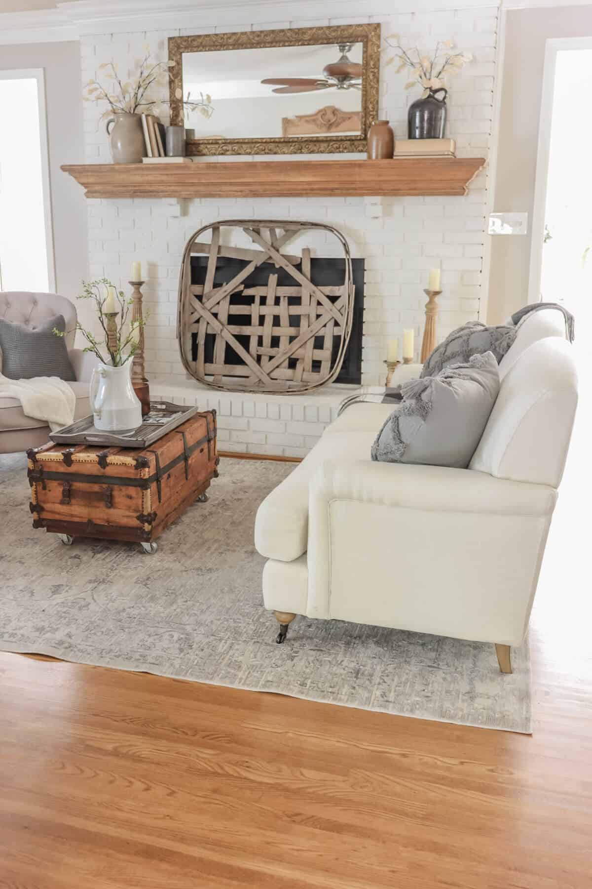view of living room with fireplace with tobacco basket