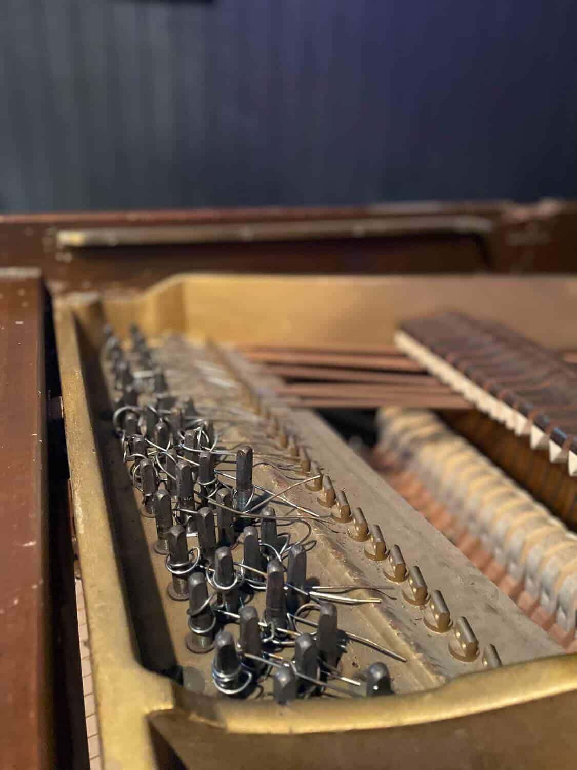 An old piano beyond repair being taken apart