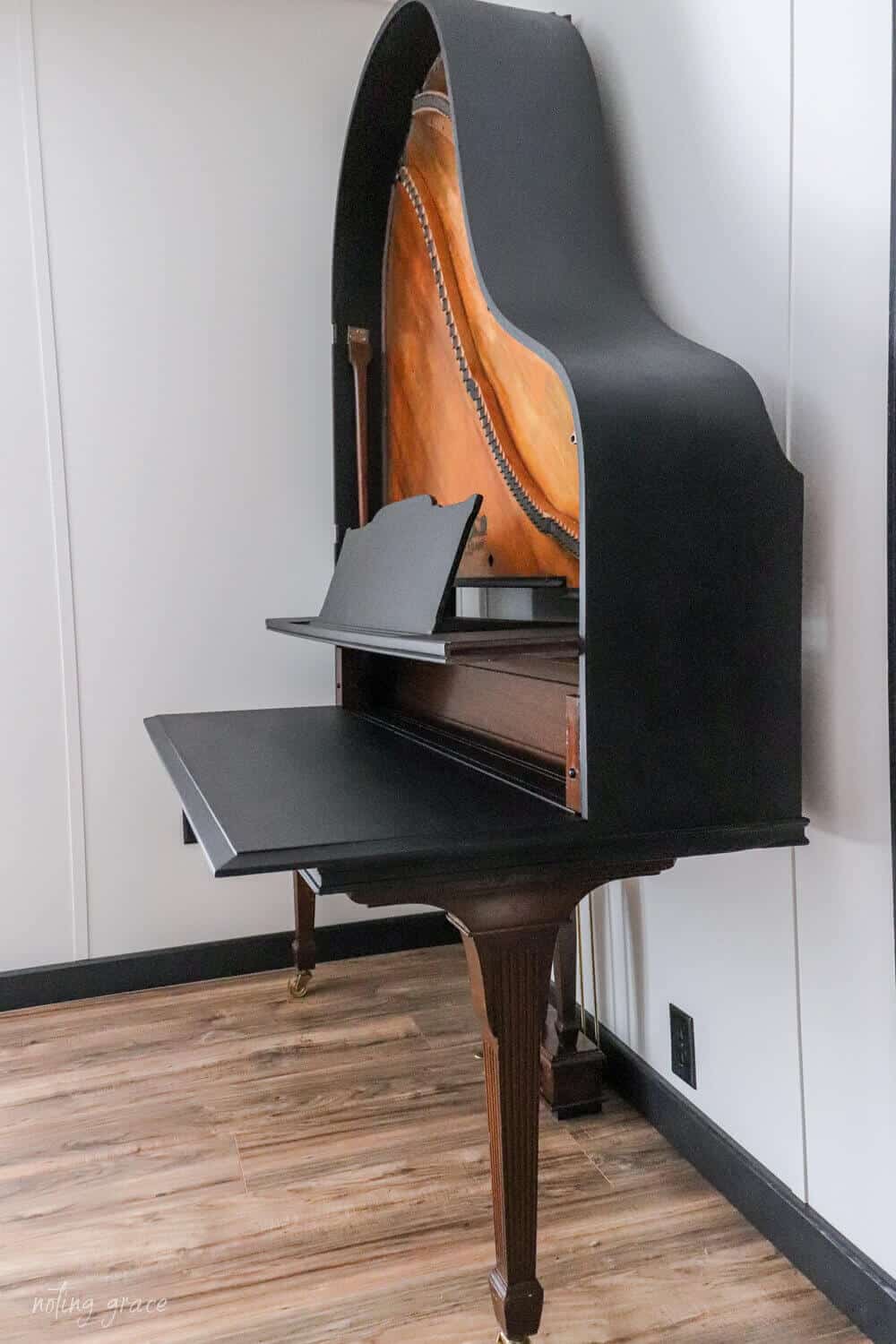 old piano reinvented into a desk or keyboard stand
