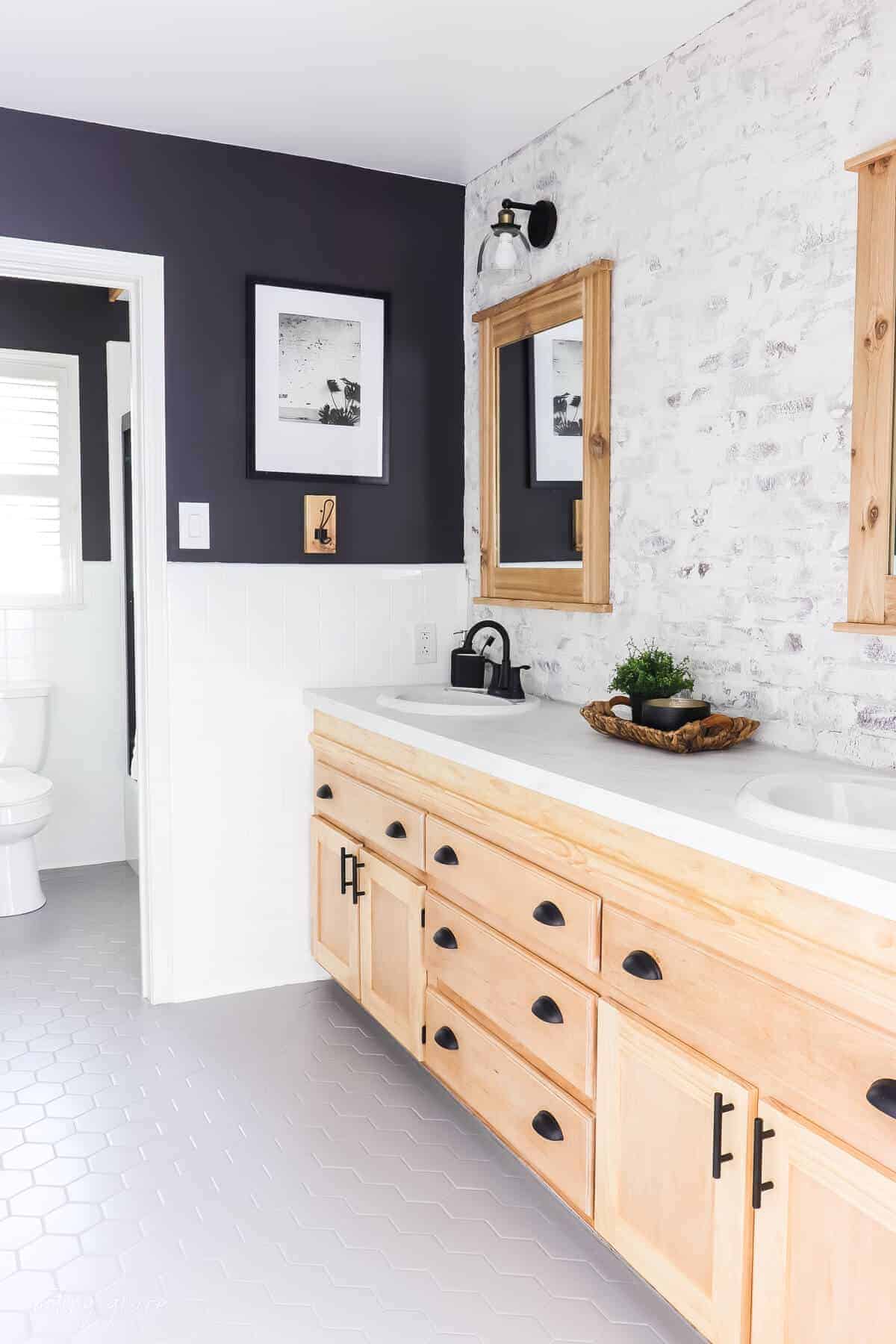 Changed bathrooms tiles for $150 bucks with white painted tile walls with gray painted hexagon tile floor with black painted walls and cedar wood elements.