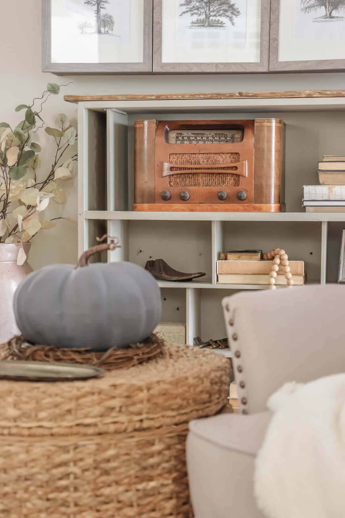 Vintage radio on a shelf with old books and gray fall decor