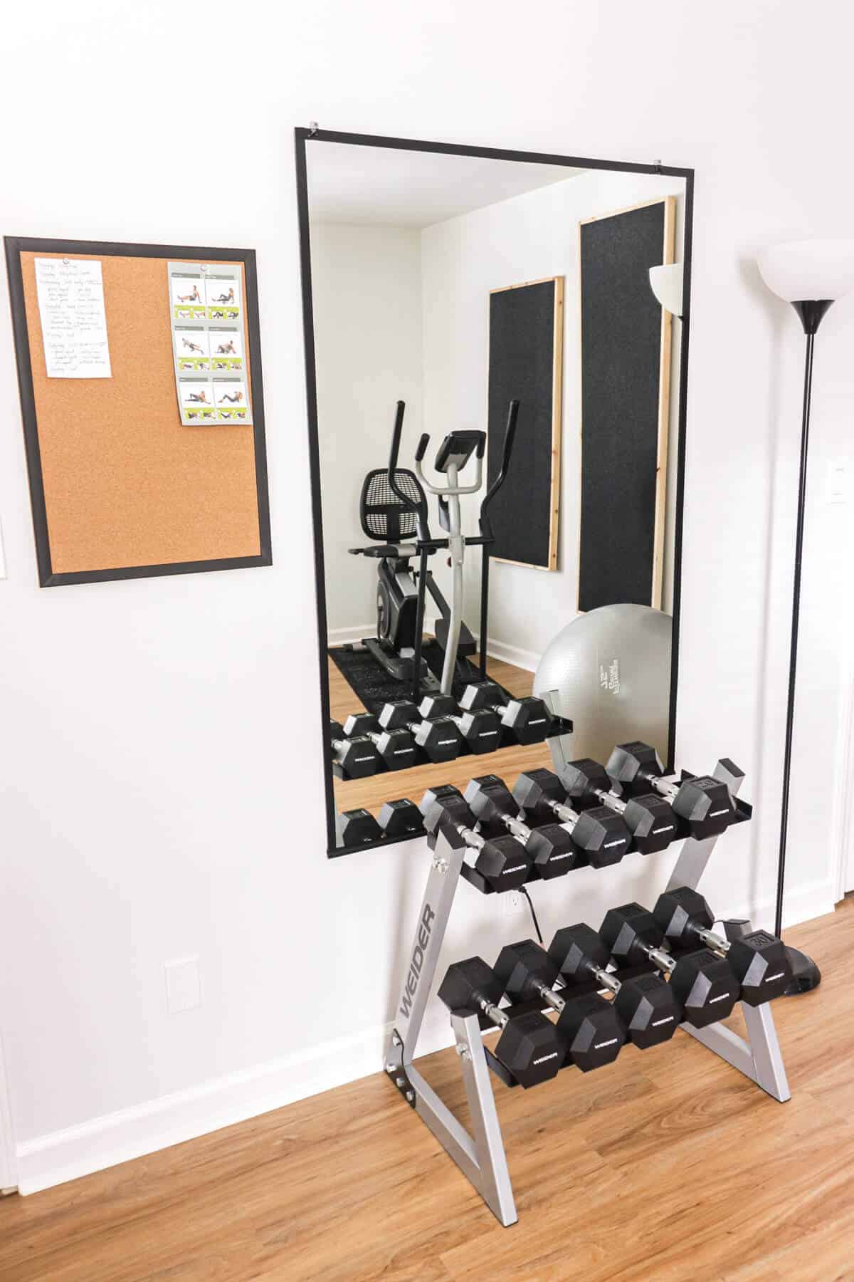 free weight rack in front of a mirror