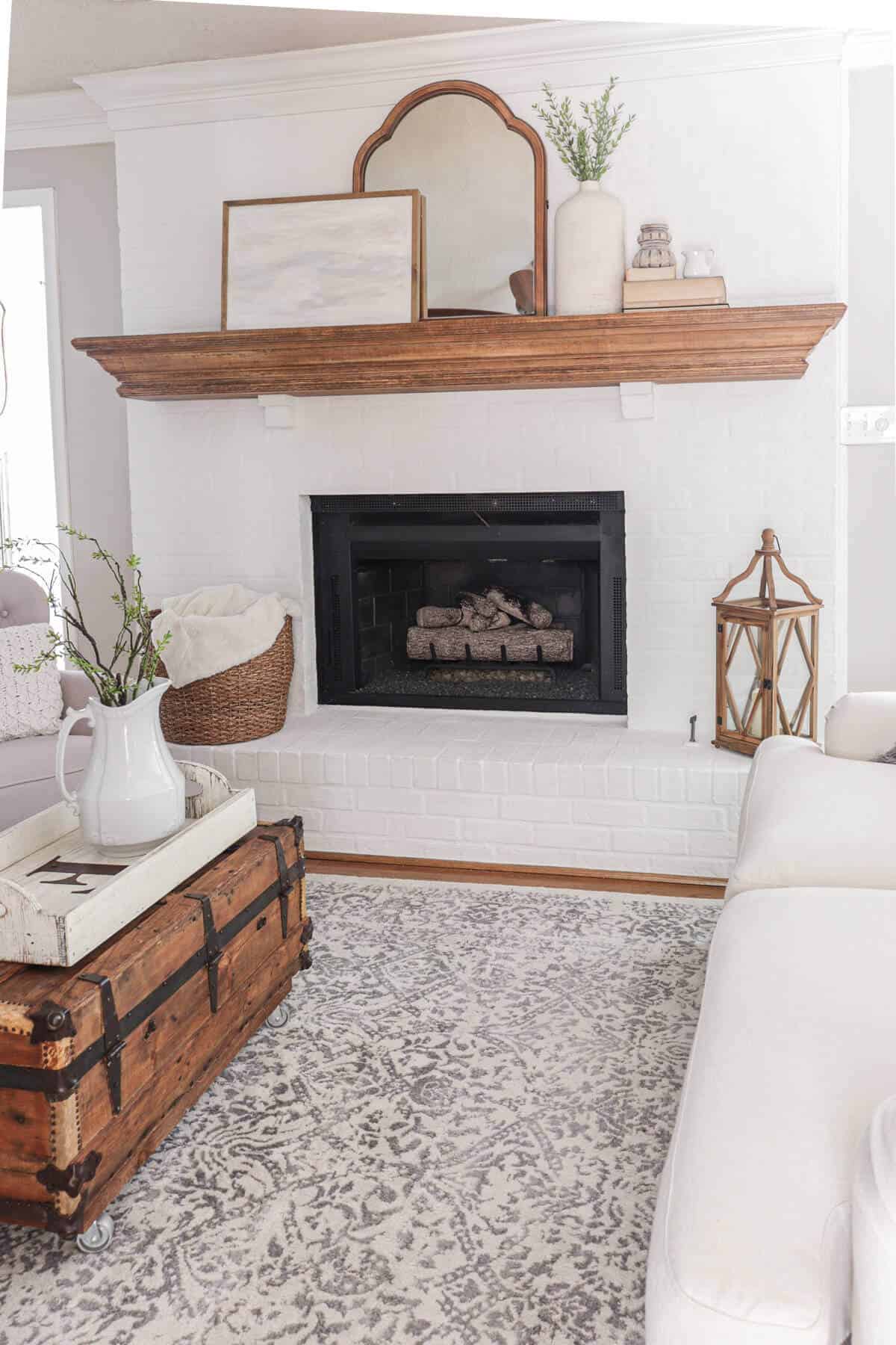 lime slurry fireplace with wooden mantel and gas fireplace logs