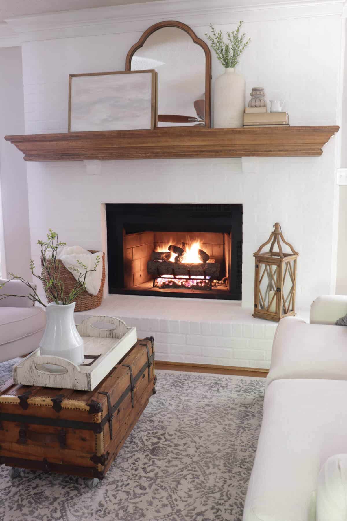 lime slurry fireplace with wooden mantel and gas fireplace logs