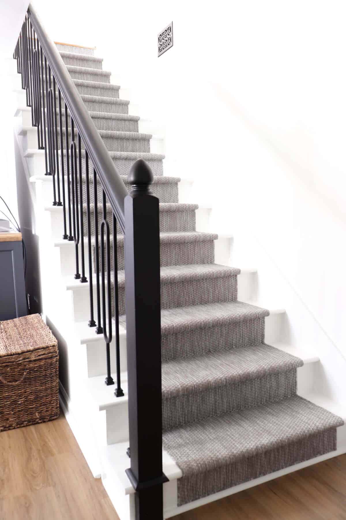 Updated stairway with new carpet runner and iron balusters