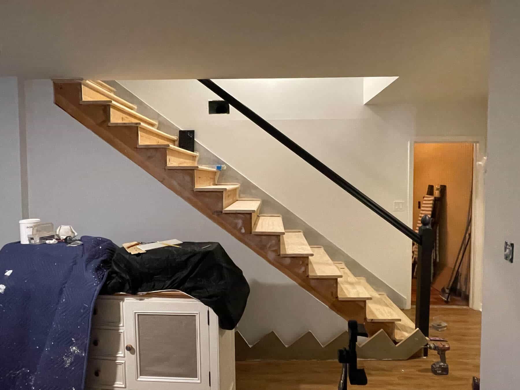 basement stair remodel with black handrail installed