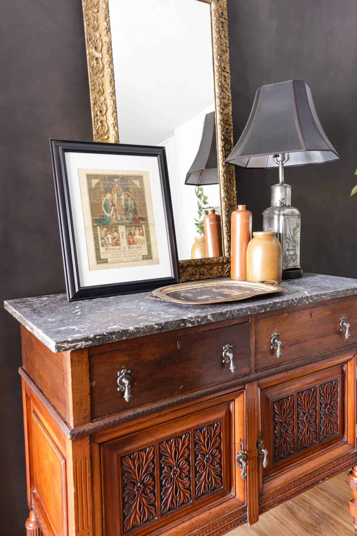 vintage carved chest with heirlooms decorating the top