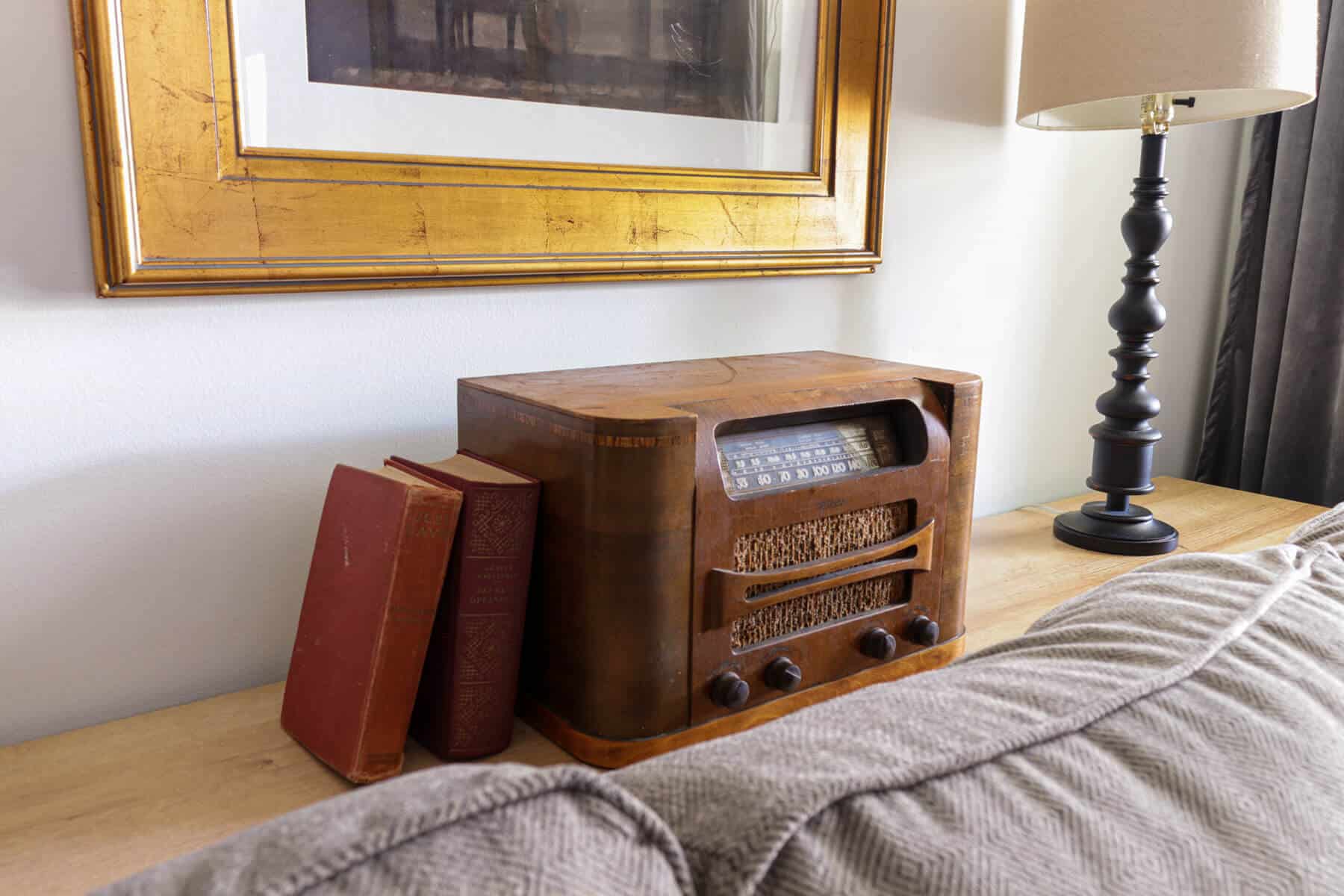 vintage radio on a table behind a gray sofa