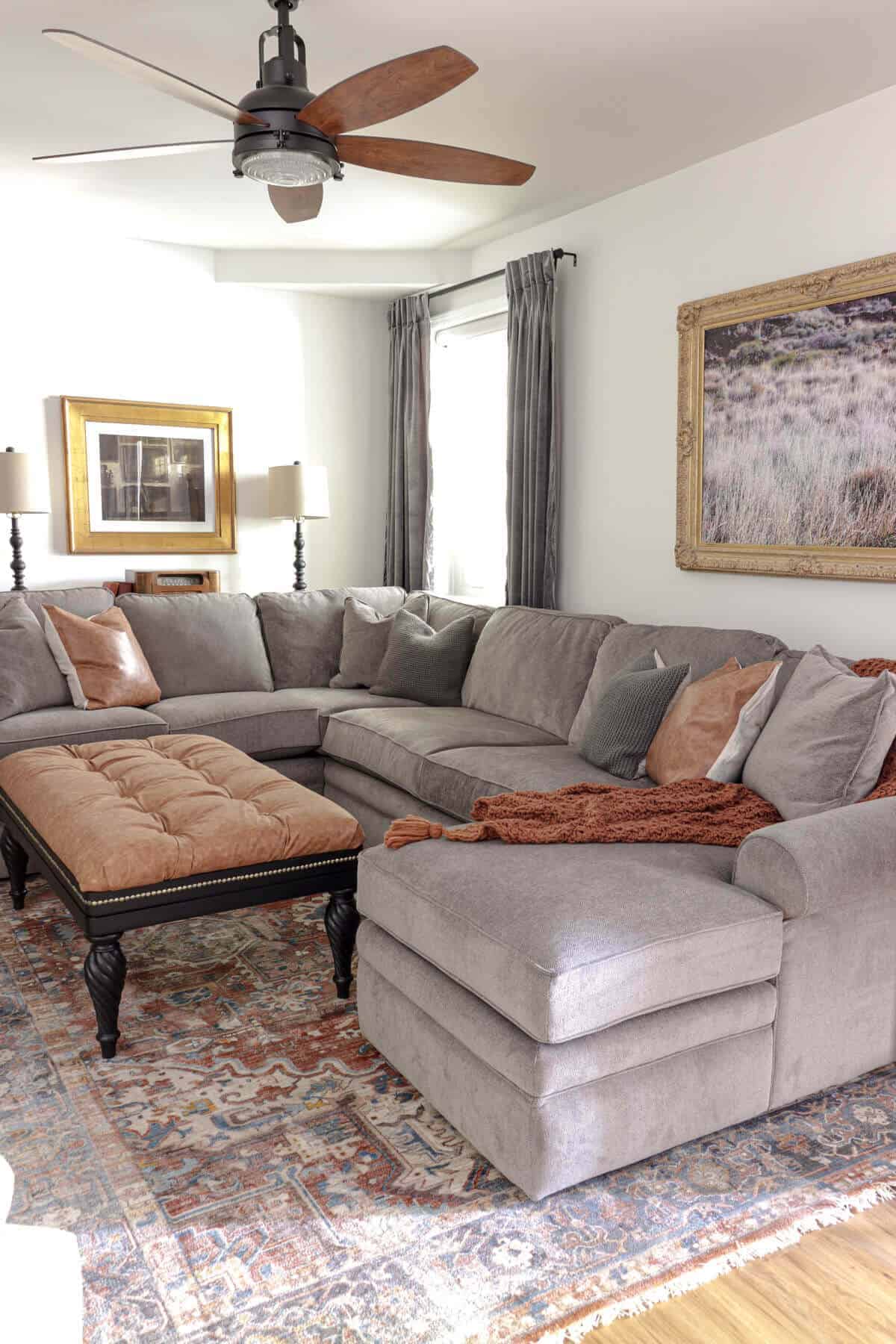 gray lazboy sectional sofa in a basement room with cognac leather accents and tufted ottoman