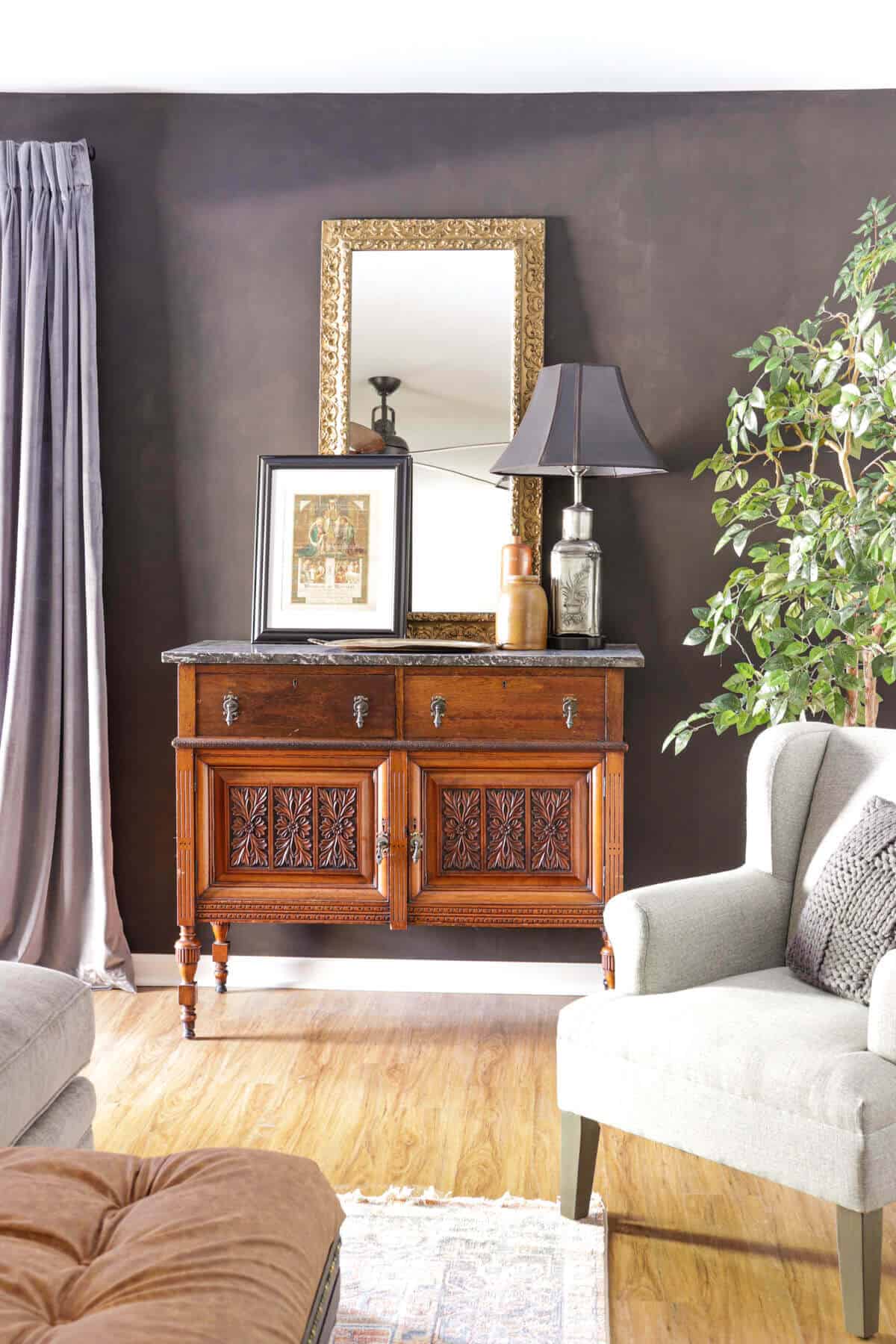 charcoal accent wall with vintage chest and decor in front