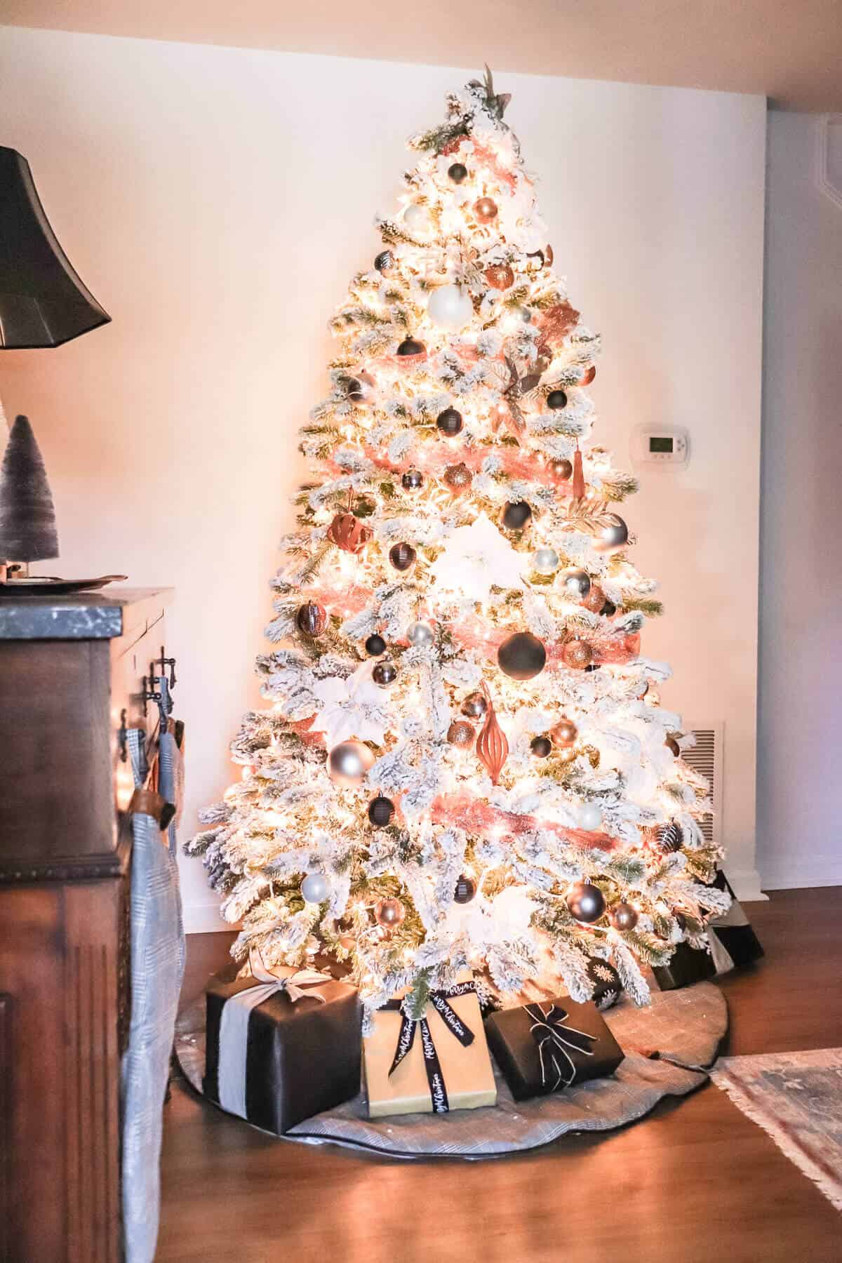 moody flocked Christmas tree with copper gray and leather ornaments