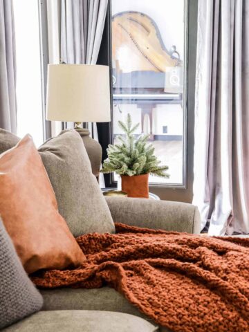 gray sectional with copper blanket