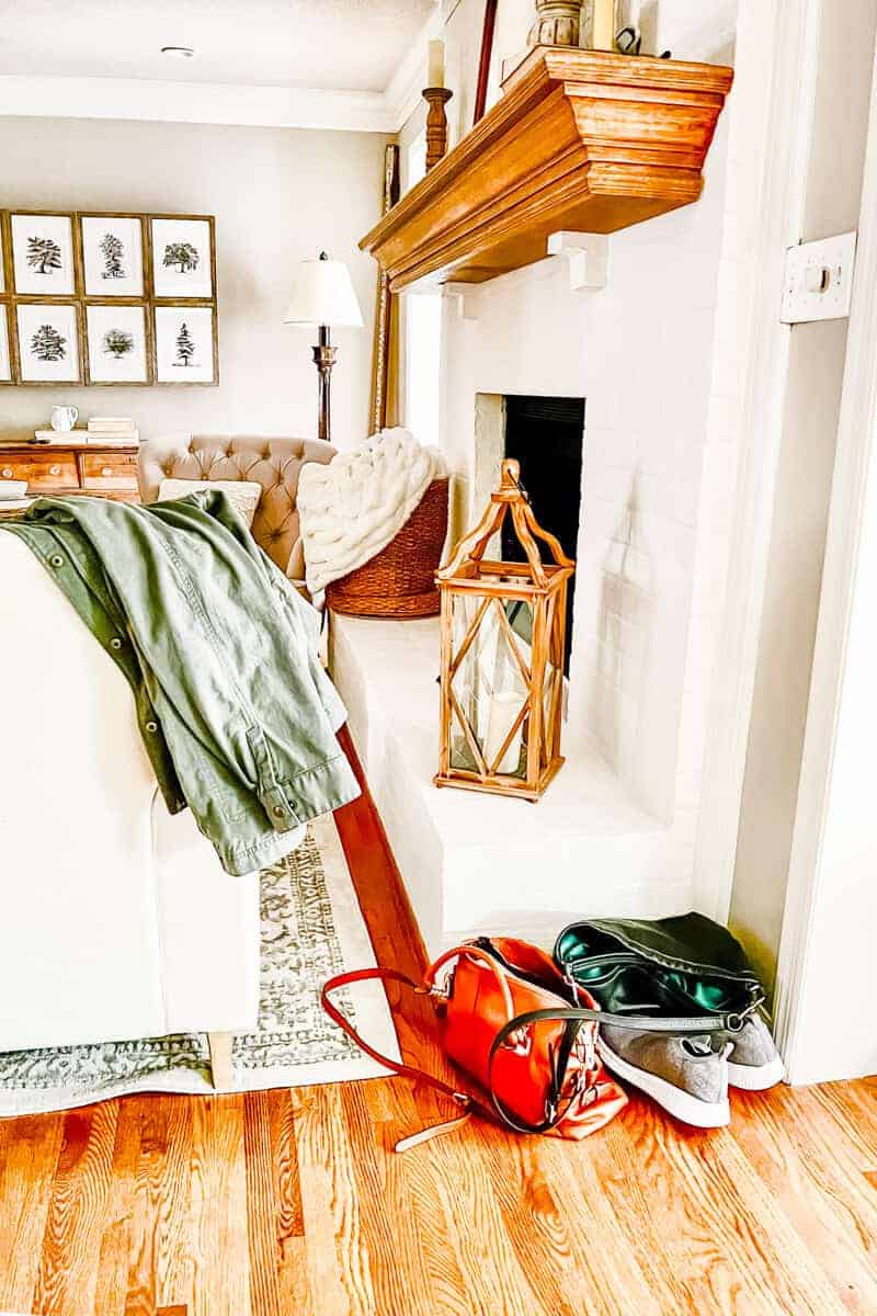 long shot of living room with a coat, purse and shoes dropped on the floor