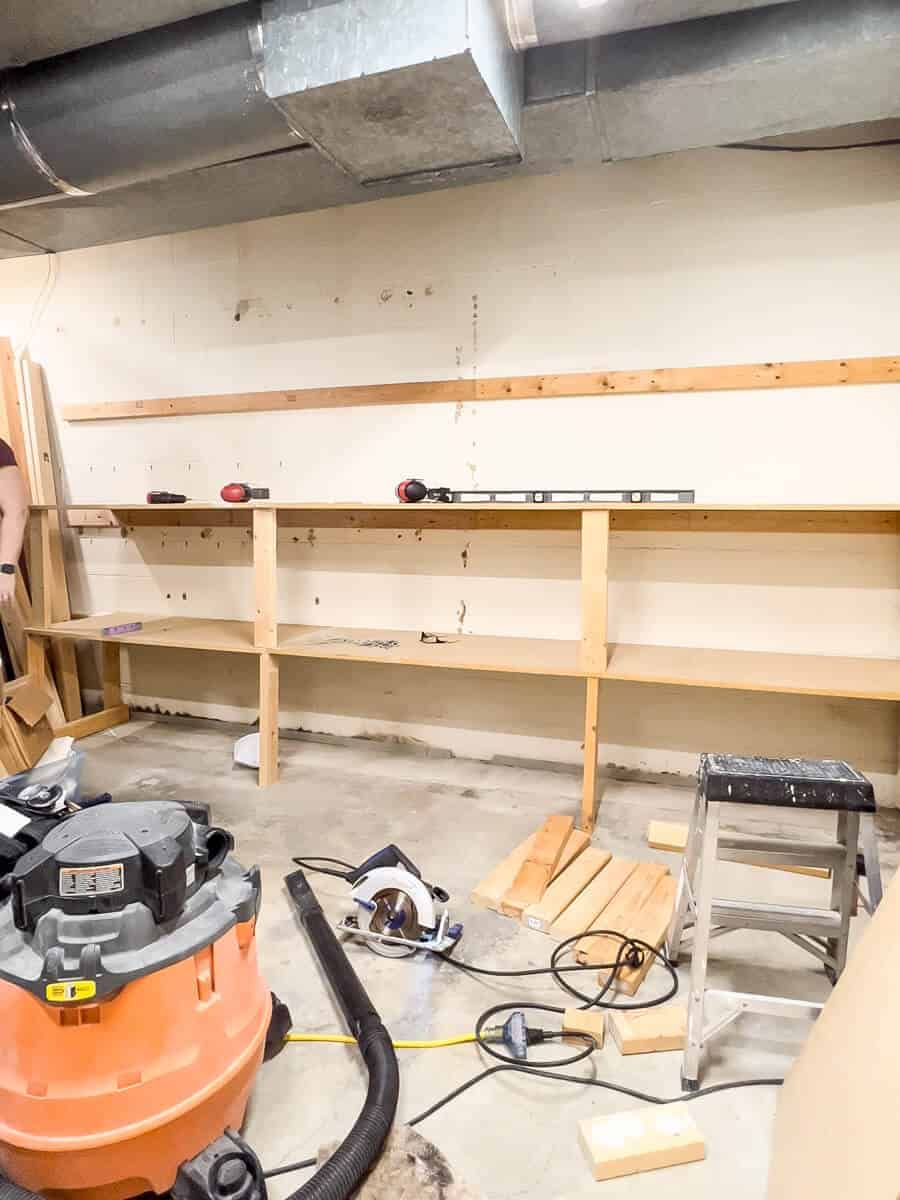 mdf shelves being installed in a basement