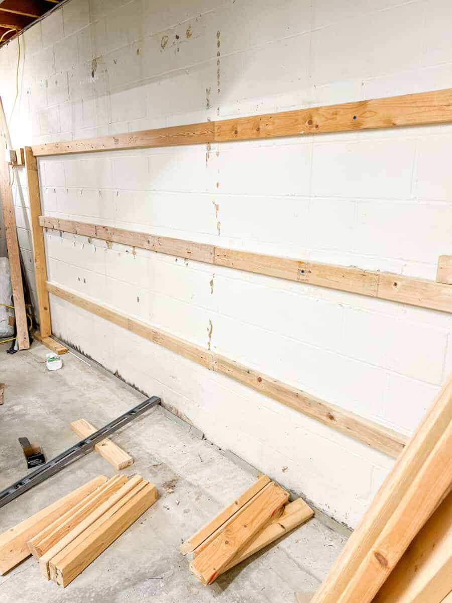 2 x 4 ribs installed on cinder block wall ready for shelving install