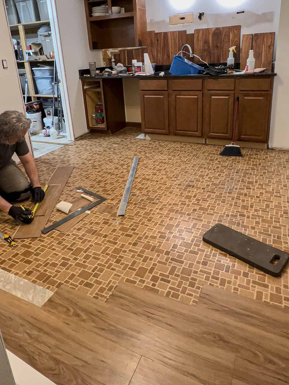 old linoleum floor getting a luxury vinyl tile installed over top
