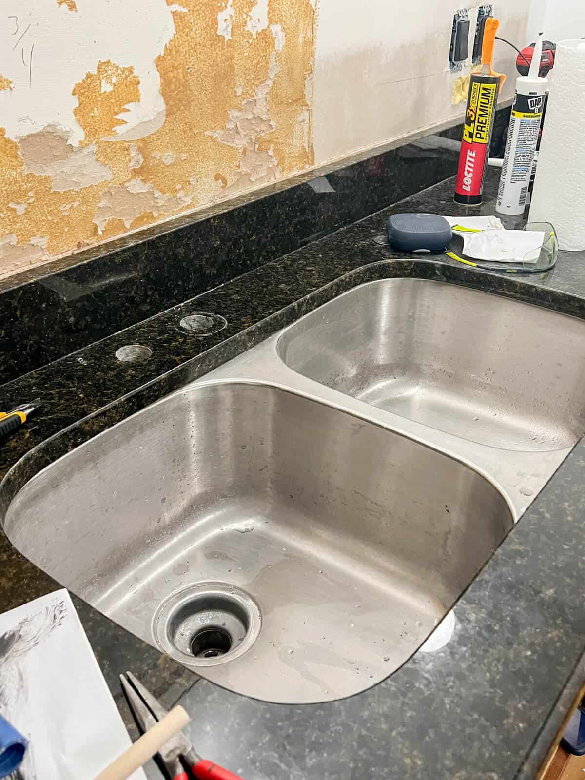 old stainless sink ready to be removed and replaced with a new sink